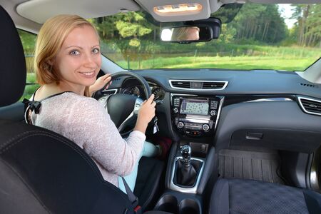 woman sit in modern  car in front of dashboardの写真素材