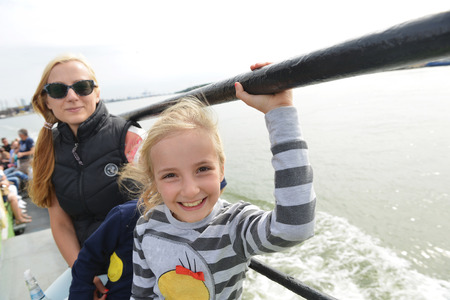 mother with children sailing  on passenger ferry in seaの写真素材