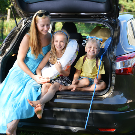 mother and her children sits in carの写真素材