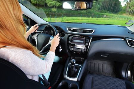 woman sit in modern  car in front of dashboard