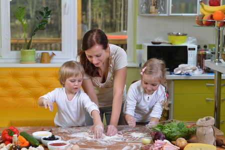 mother with children going to cook pizzaの写真素材
