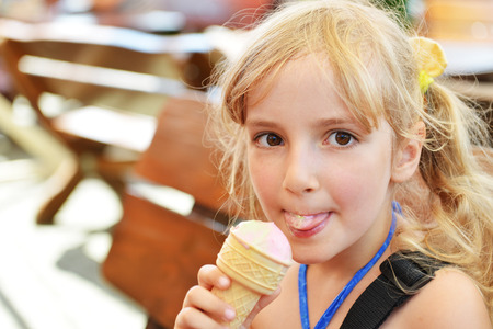 lovely blond little girl eating  ice creamの写真素材