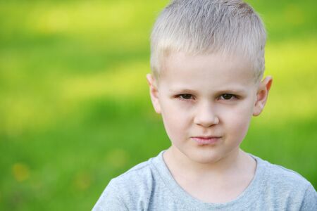 boy on green lawn. warm summer dayの写真素材