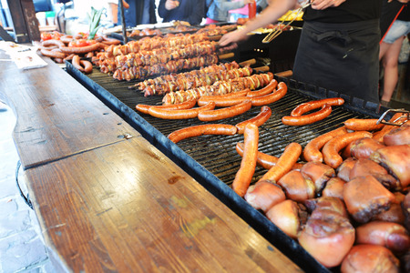 Assorted  of delicious grilled meat and sausages over the coals on a barbecueの写真素材
