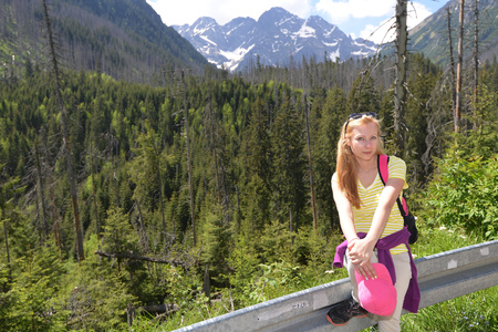 young woman on mountains slopes near roadの写真素材