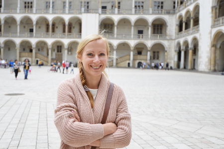 young woman on square near historic buildingの写真素材