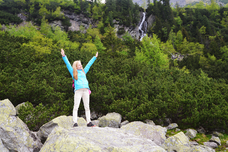 young woman in blue jacket on mountains slopesの写真素材