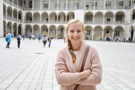 young woman on square near historic buildingの写真素材