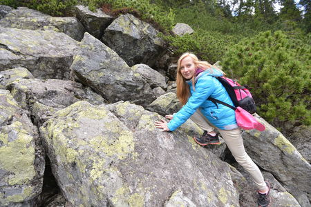 young woman in blue jacket on mountains slopesの写真素材