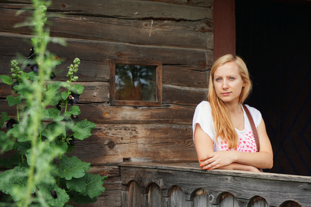 beautiful woman at porch wooden houseの写真素材