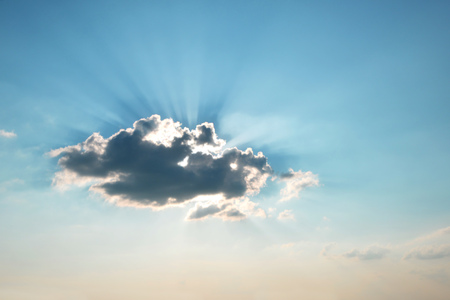 rays of sun breaking through cloudの写真素材