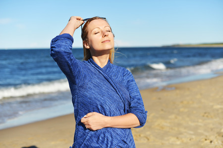 Young woman walking on sand beachの写真素材