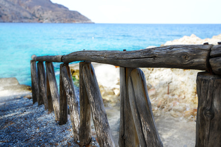 wooden fence  by blue sea shoreの写真素材