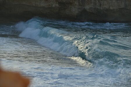 waves splash at stones on shore sea