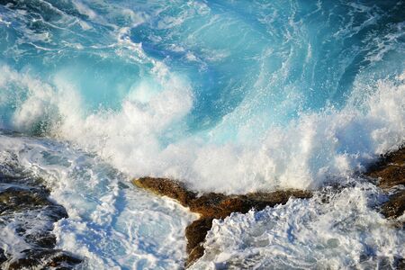 foam  waves splash at stones on shore sea