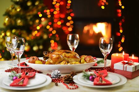dinner with chicken near Christmas treeの写真素材