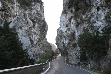 serpentine road winds through mountainの写真素材