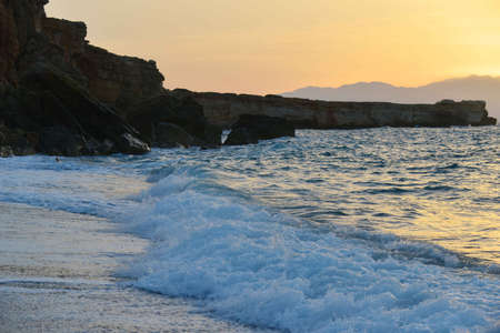 waves splash at stones on shore sea