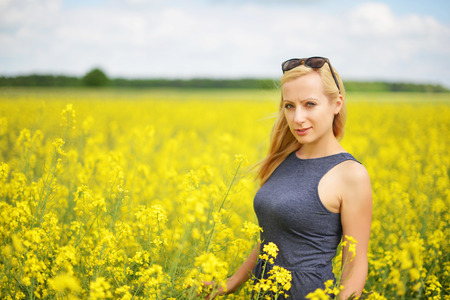 Charming woman at  field of canolaの写真素材