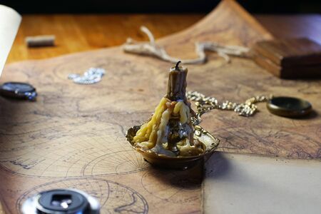 candle lie on old ancient mapの写真素材