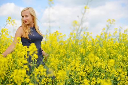 Charming woman at  field of canolaの写真素材