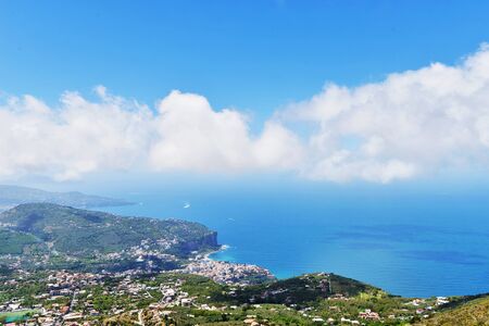 resort city in mountains and sky with cloudsの写真素材