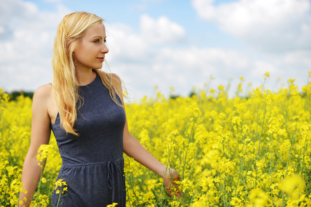 Charming woman at  field of canolaの写真素材