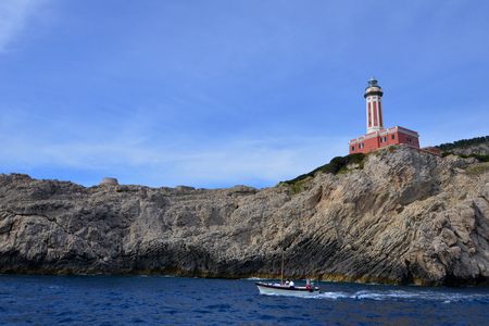 Rocks and sea under blue sea. lighthouse on mountainの写真素材