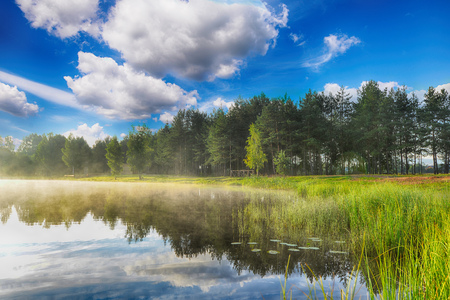 summer landscape. blue sky, clouds and waterの写真素材