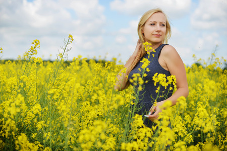 Charming woman at  field of canolaの写真素材