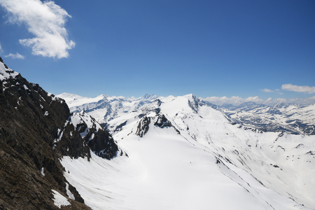 capped mountain peaks and blue skyの写真素材