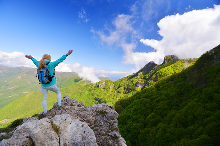 Woman stand at top of mountainの写真素材