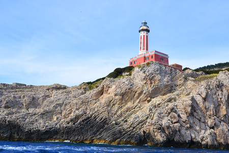 Rocks and sea under blue sky. lighthouse on mountainの写真素材