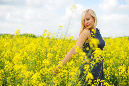 Charming woman at  field of canolaの写真素材