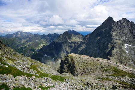 slopes and peaks of mountains and blue sky landscapeの写真素材
