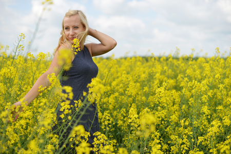 Charming woman at  field of canolaの写真素材