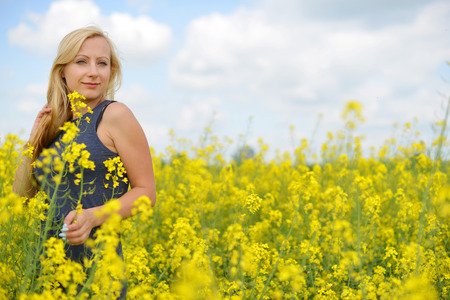 Charming woman at  field of canolaの写真素材