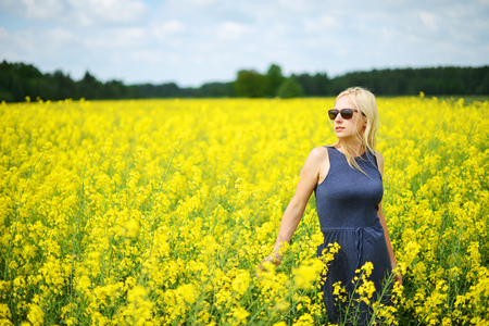 Charming woman at  field of canolaの写真素材