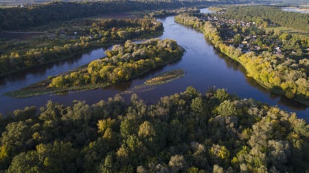 top view on field, trees and riverの写真素材