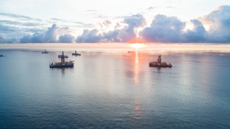 small seagoing ships floating off coast resortの写真素材