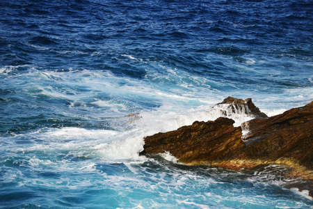 waves splash at stones on shore sea