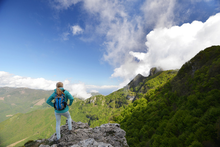 Woman stand at top of mountainの写真素材