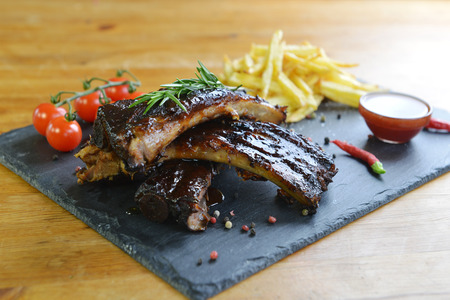 fried potatoes and pork ribs on aplateの写真素材