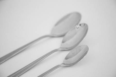 Three spoons of different sizes in black and whiteの写真素材
