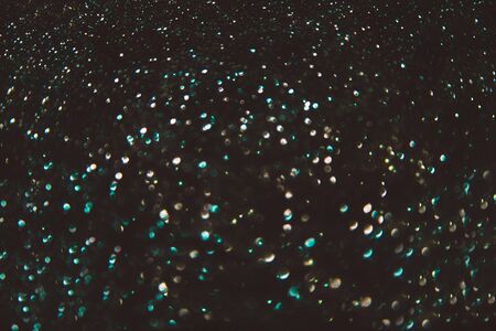 Abstract bokeh on black background like starsの写真素材