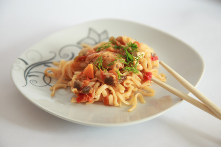 Spaghetti on white background with chinese sticks.の写真素材