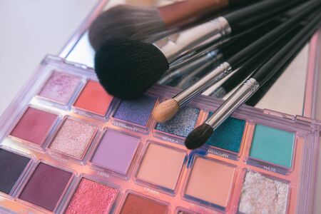 Makeup brushes and color palete on white backgroundの写真素材
