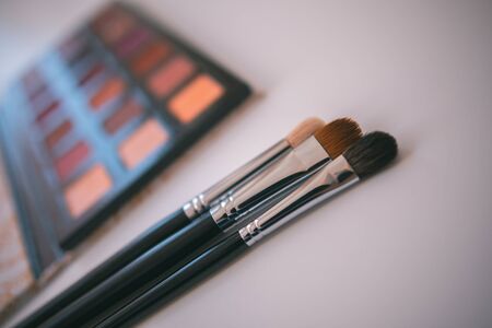 Makeup cosmetics tools background & beauty cosmetics, products & facial cosmetics package lipstick, eyeliner, concealer, mascara, eye shadow stick & highlighter palette on white color background.の写真素材