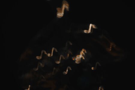 Gold notes on black backgroundの写真素材