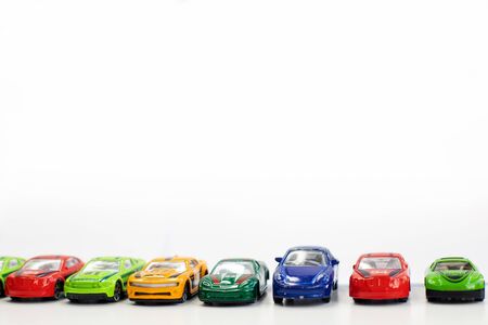 Toy cars of different colors arranged on a white background.